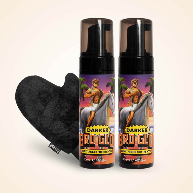 Two spray tan bottles with purple labels beside a black heart-shaped applicator mitt.