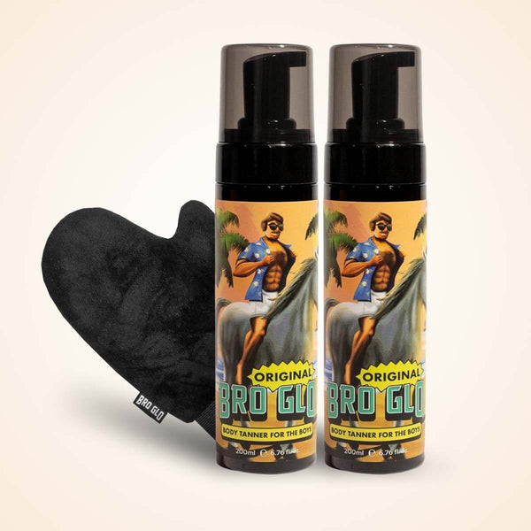 Two spray bottles with tropical artwork next to a black heart-shaped applicator mitt.