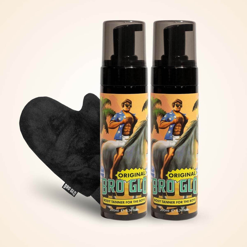 Two spray bottles with tropical artwork next to a black heart-shaped applicator mitt.