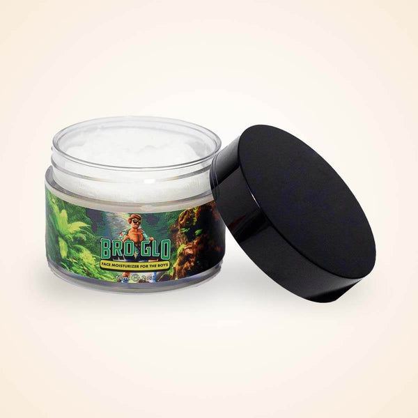 An open jar of white moisturizing cream with a black lid resting beside it against a beige background.