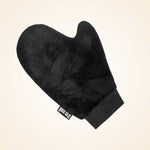 Black velvet applicator mitt with ribbed cuff and wrist band against cream background.