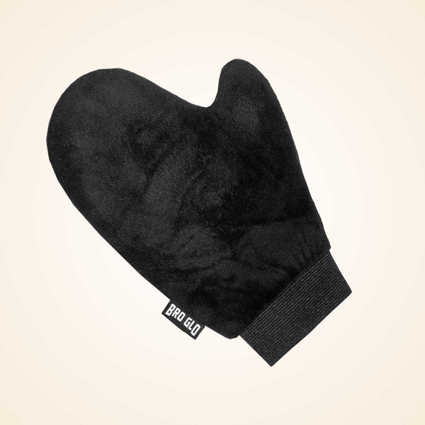 Black velvet applicator mitt with ribbed cuff and wrist band against cream background.
